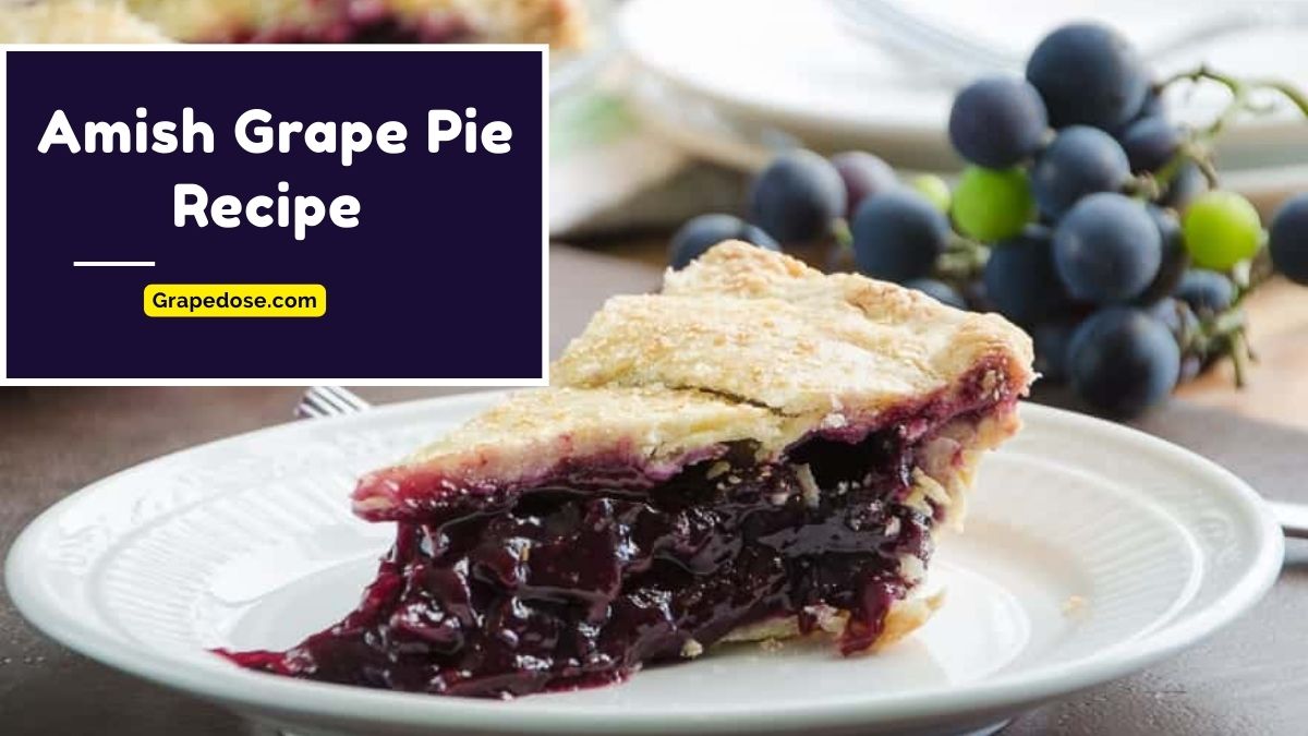 Amish grape pie with a golden flaky crust filled with sweet, juicy grapes on a plate